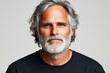 © Pixel Mind - Mature man with silver hair and beard posing confidently against a neutral background