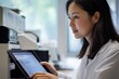 © Art - A female scientist in a lab coat analyzes data on a tablet, focusing intently on graphs and charts.