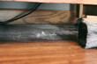 © Caroline - close-up of dust and lint under furniture. dusting wood surfaces. housework, chores, or preparing home for sale. home interior graphic design element.