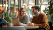 © karina_lo - Smiling young couple enjoys coffee and laptop in cozy café with warm lighting and green plants creating relaxed atmosphere