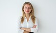 © Valentyna - Woman in white shirt stands against plain white background smiling.