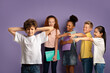 © Prostock-studio - Bullying at schools concept. Cruel schoolkids harassing unhappy little boy on lilac background