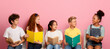 © Prostock-studio - Back to school. Diverse children with notepads and books looking at each other while sitting on chairs over pink background
