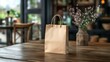 © Sleeping Carbuncle - Beige Paper Bag Centered on Shiny Wooden Table With Flowers in Blurred Cafe