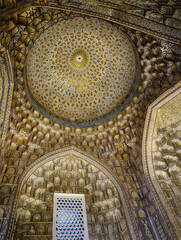 Golden patterns highlighting ornate dome and walls of historic gur-e amir mausoleum, featuring classic islamic architectural design in samarkand, uzbekistan