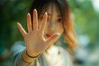 © ArtFocus Studio - Close-up of a Woman's Hand Making a Stop Gesture. A Portrait Showing Refusal, Rejection, Defense, Protection, Warning, Alert, and Caution.