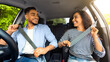 © Prostock-studio - Happy millennial arab couple fastening seat belt, looking at each other and smiling, going vacation by auto, shot from dashboard. Mixed race young family having weekend trip, enjoying nice weekend