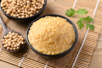 Wall Mural - Miso paste in black bowl, Japanese seasoning made from fermenting soybeans with salt, Traditional food ingredient in Japanese cuisine