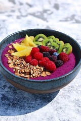 Canvas Print - Berry bowl close-up on table. Fruit breakfast, granite background. Healthy snack; wellness advert