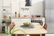 © Pixel-Shot - Wicker bowl with apples on dining table in kitchen