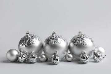 Wall Mural - Silver Christmas baubles on grey background