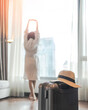© Chinnapong - Luggage suitcase with traveler guest waking up in business hotel, city apartment home, condominium moving for work travel, or staying for holiday vacation trip booking a room for hospitality service