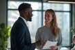 © He - Two people African American man Caucasian woman office conversation