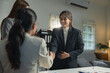 © crizzystudio - Professional women in a modern office setting engaging in a handshake, symbolizing successful collaboration and teamwork. Bright, well-lit space with a focus on professional interaction