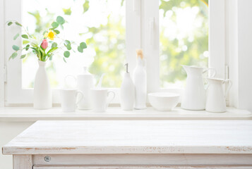 Wall Mural - bleached wooden table top on bright white kitchen window sill interior background with kitchenware