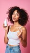 © Giuseppe Cammino - Woman surprise showing product. Beautiful girl with curly hair pointing to the side. Presenting your product. Expressive facial expressions