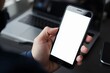 © SR Creative Idea - Person holding smartphone with blank screen laptop in background modern technology concept