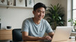 © kineter_ai - Young East Asian man in a cozy sunlit home office, smiling at a virtual meeting with diverse colleagues
