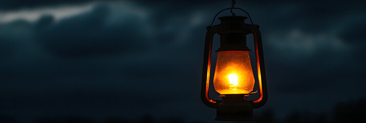 Wall Mural - the warm glow of lantern light against a twilight sky wide banner - black background