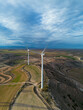 © yaqui_villegas - Aerial perspective of a wind farm, illustrating large-scale renewable energy infrastructure integrated with nature.