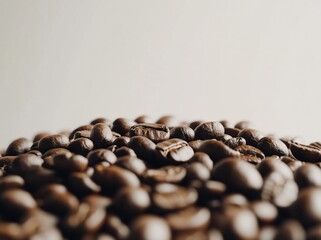 Wall Mural - Close-up of a pile of dark roasted coffee beans against a bright background.