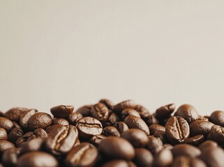 Wall Mural - Close-up of roasted coffee beans against a light background.