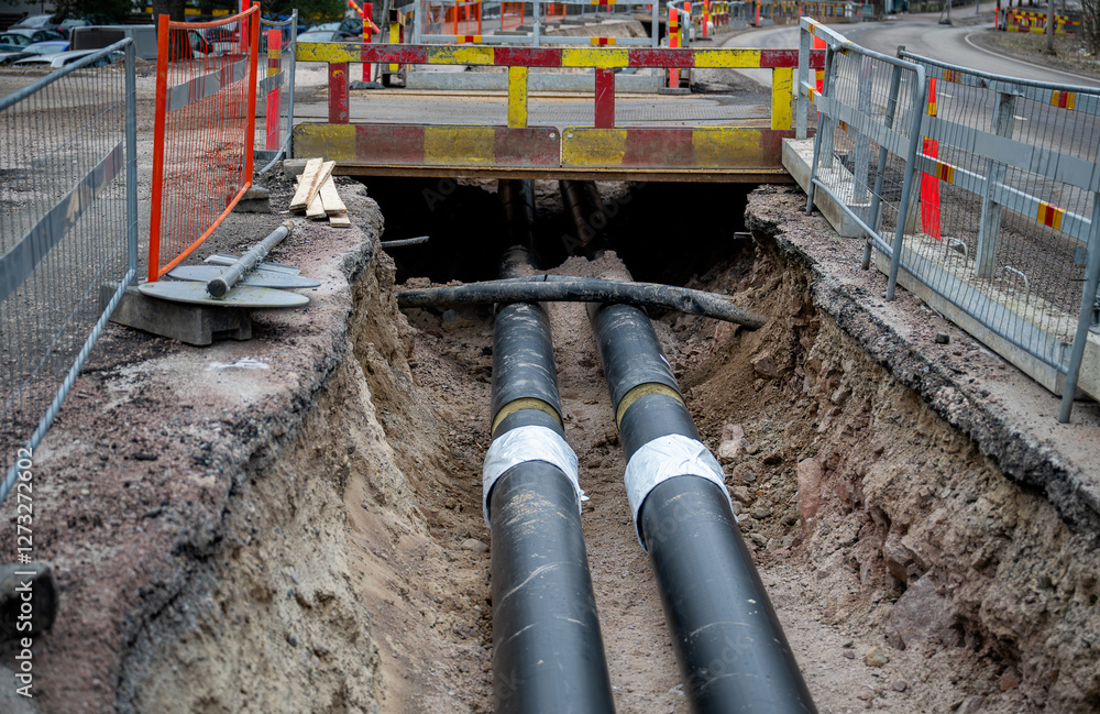 Underground Pipe Rasp Large black underground pipes being installed in an excavated trench at ...
