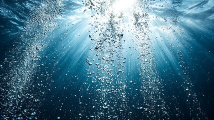 Fototapete - Bubbles rise from the depths underwater. Sunbeams illuminate the ocean. For exploration, science
