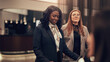 © Flamingo Images - Diverse businesswomen working in the lobby of a hotel during a business trip. They are both wearing blazers