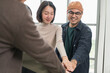 © PhugunStock - Asian business men and women join forces to check hands happily. Brainstorm and talk about analytics, innovation, and collaboration. online business Modern sales techniques and strategic planning