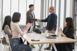 © PhugunStock - Happy Asian business men holding hands, brainstorming, talking about analysis, innovation and collaboration. Online business, sales techniques, strategic planning