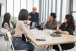 © PhugunStock - Asian male businessman standing explaining meeting, smiling happily and brainstorming, discussing analysis, innovation, collaboration. online business Modern sales techniques and strategic planning