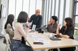 © PhugunStock - Asian male businessman standing explaining meeting, smiling happily and brainstorming, discussing analysis, innovation, collaboration. online business Modern sales techniques and strategic planning