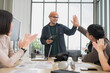 © PhugunStock - Asian male businessman Tag hands with friends, holding tablets, to brainstorm and talk about analysis, innovation, and collaboration. Online business, sales techniques, modern strategic planning