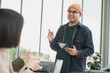 © PhugunStock - Asian male businessman standing explaining meeting, smiling happily and brainstorming, discussing analysis, innovation, collaboration. online business Modern sales techniques and strategic planning