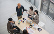 © PhugunStock - Top view of business people, Asian man and woman looking at camera, hands raised, happy, talking about analysis, innovation and collaboration. Online business, sales techniques, strategic planning