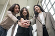 © PhugunStock - Asian business woman Join forces with friends, look into the camera, brainstorm and talk about analysis, innovation, and collaboration. Online business, sales techniques, modern strategic planning