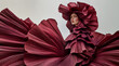 © Sandra Chia - Fashion editorial Concept. Freckle woman of high fashion couture tulle flowing conceptual and pleats petal like maroon deep red bridal angel dress and headgear hat. copy text space