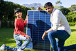 © Wavebreak Media - indian father and son installing solar panel together in green garden