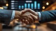 © kodidesign - Close-Up Handshake Between Business Professionals in a Corporate Setting with Financial Graphs in the Background for Partnership, Success, and Business Agreement Concepts