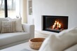 © Atlas Studio - Cozy living room featuring a modern fireplace and soft furnishings in a bright, minimalist setting