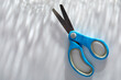© Tetra Images - Blue children's scissors on white background