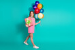 © deagreez - Full body photo of attractive teen woman birthday air balloons present dressed checkered pink clothes isolated on cyan color background