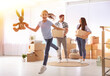 © New Africa - Happy family in sunlit room with cardboard boxes on moving day