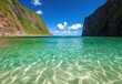 © A4719 - Clear turquoise water of a tropical bay, viewed from just above the surface, with verdant hills rising on either side under a bright blue sky with