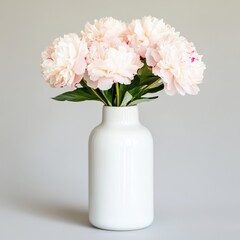 Wall Mural - Elegant bouquet of peonies in a white vase against a light background