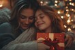 © Simran - Happy mother congratulating her loving daughter with birthday at home, give her gift box and embrace. Family holidays