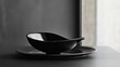 © Rauf - An empty stylish plate and gravy boat black on a black table background