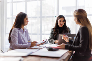 Wall Mural - Business adviser meeting to analyze and discuss the situation on the financial report in the Asian meeting room.Investment Consultant, Financial advisor and accounting concept
