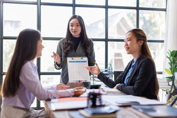 Wall Mural - Business adviser meeting to analyze and discuss the situation on the financial report in the Asian meeting room.Investment Consultant, Financial advisor and accounting concept
